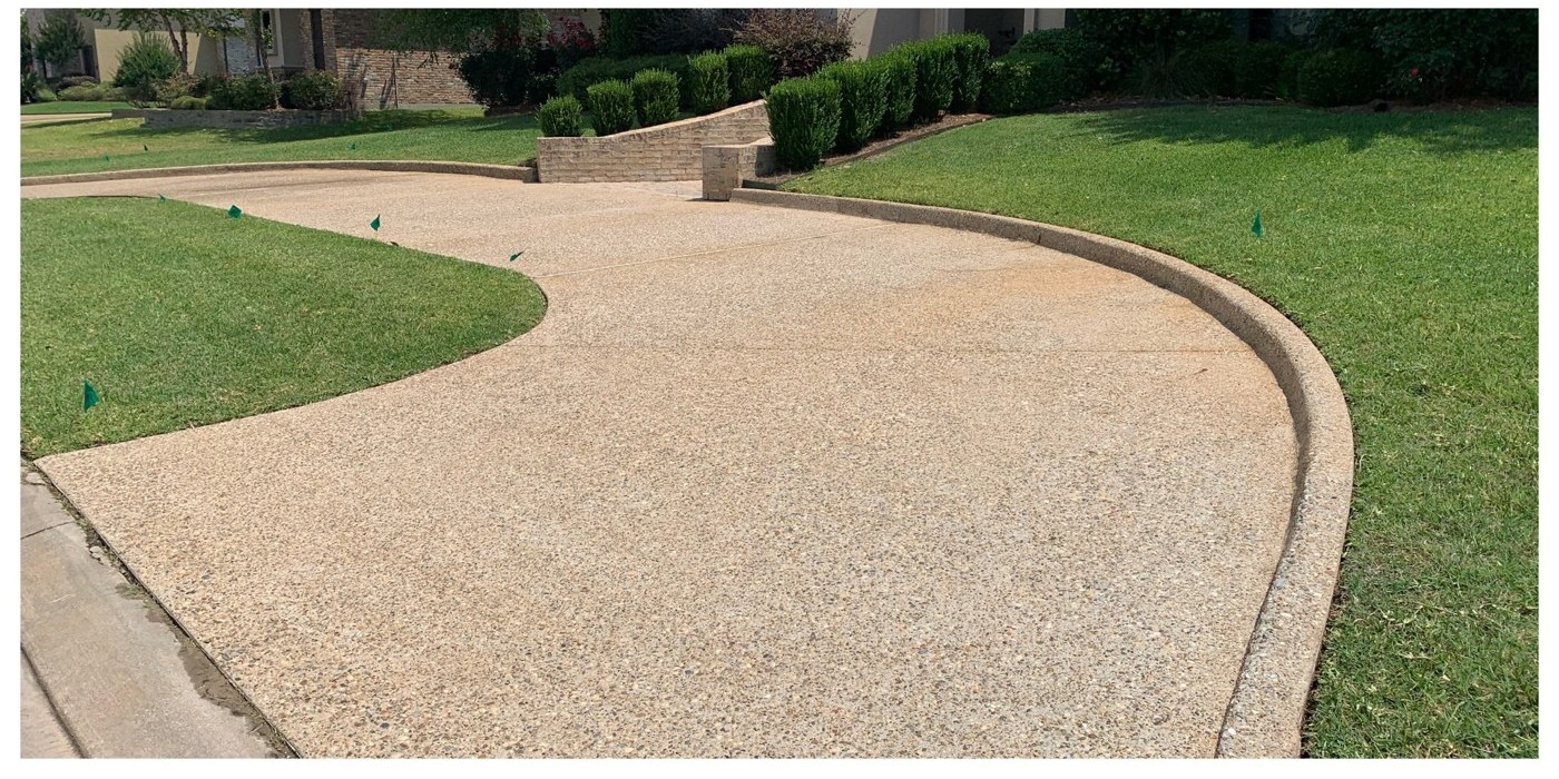 Clean driveway and neatly maintained lawn after outdoor cleaning